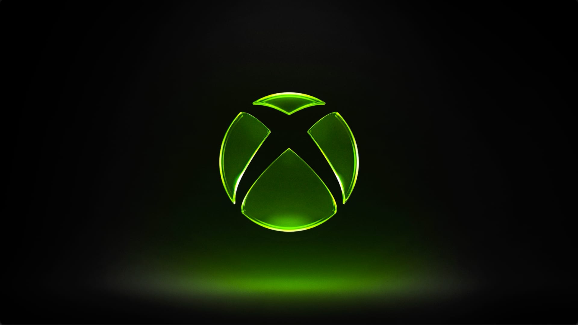Logotipo de Xbox iluminado en verde sobre un fondo negro.