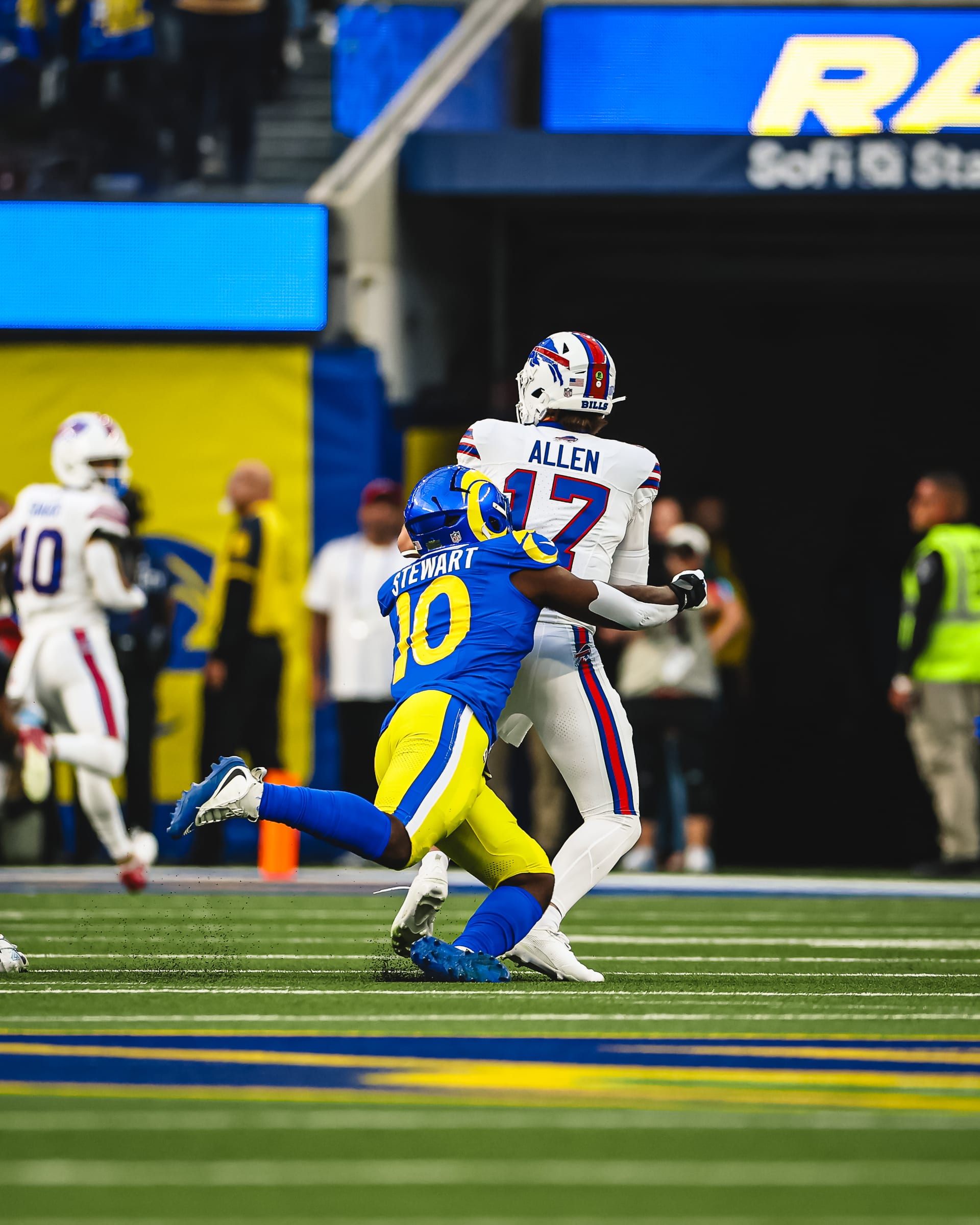 A Rams linebacker wearing number 10 grabs the Bills quarterback, number 17, from behind during the game at SoFi Stadium.