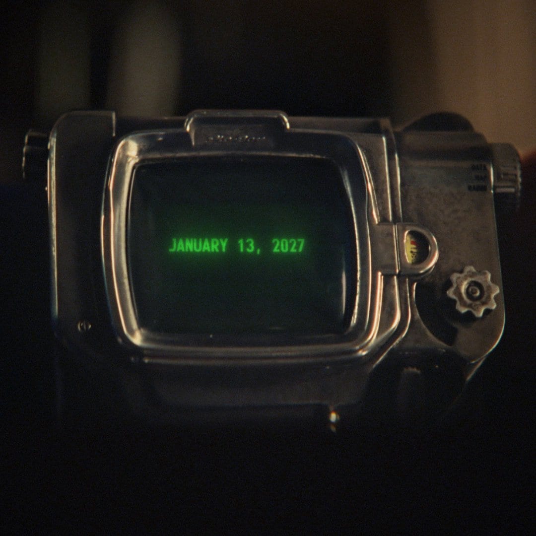 A Pip-Boy screen glows green with the date January 13, 2027, a frame from the Fallout Shelter: The Experiment teaser.