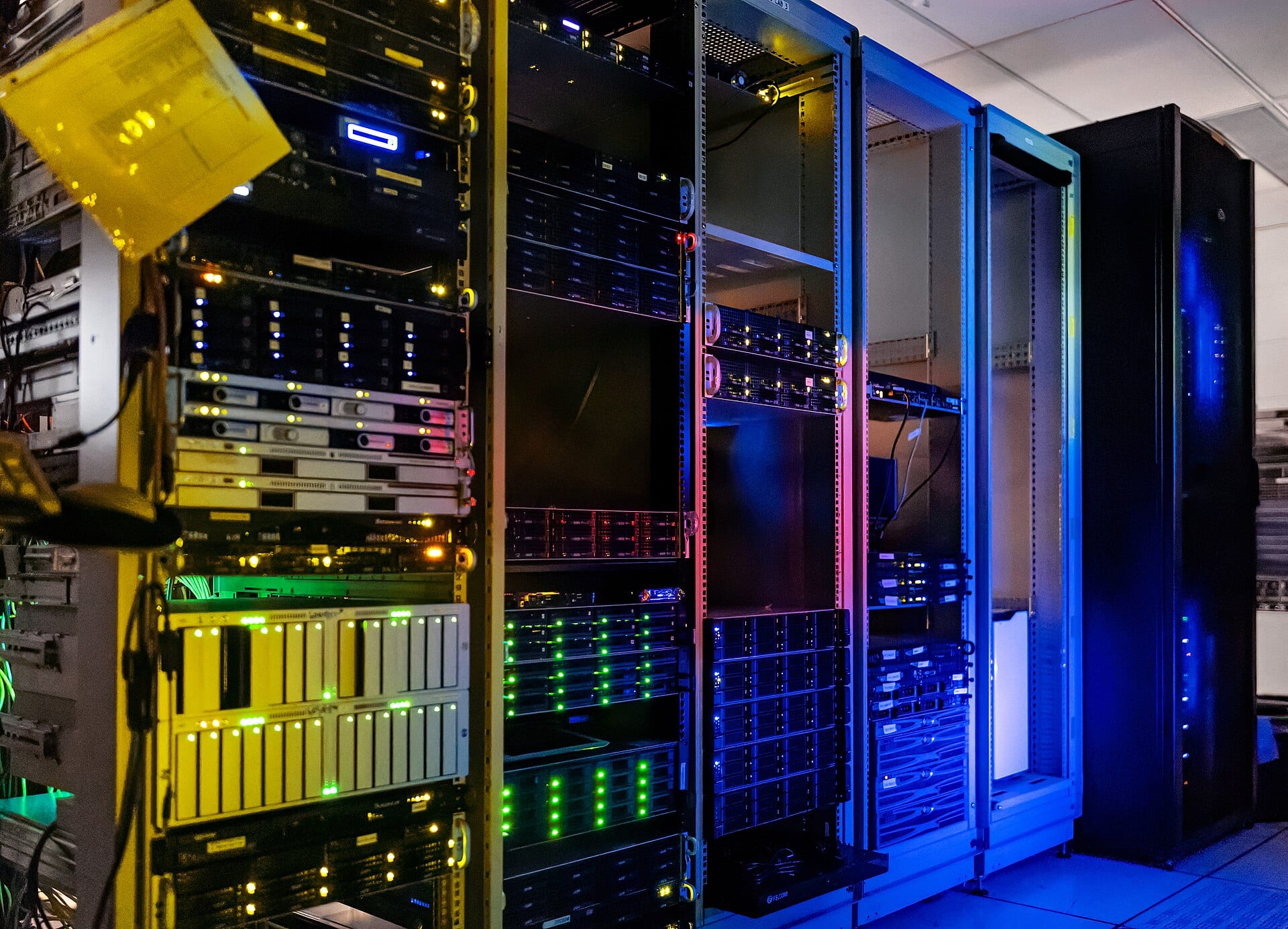 Server racks with colored indicator lights in a computer room.