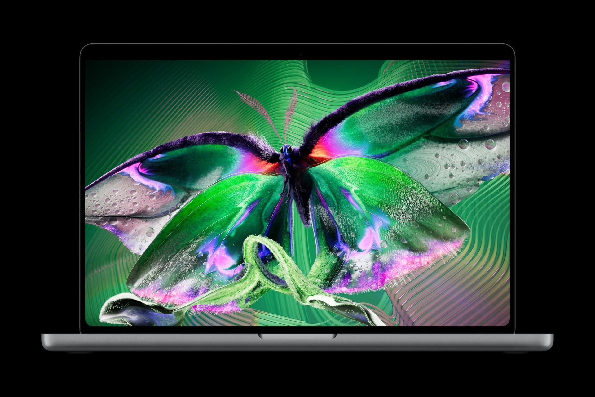 MacBook Pro abierta sobre fondo negro, con la pantalla encendida y la imagen de una mariposa de alas verdes y moradas.