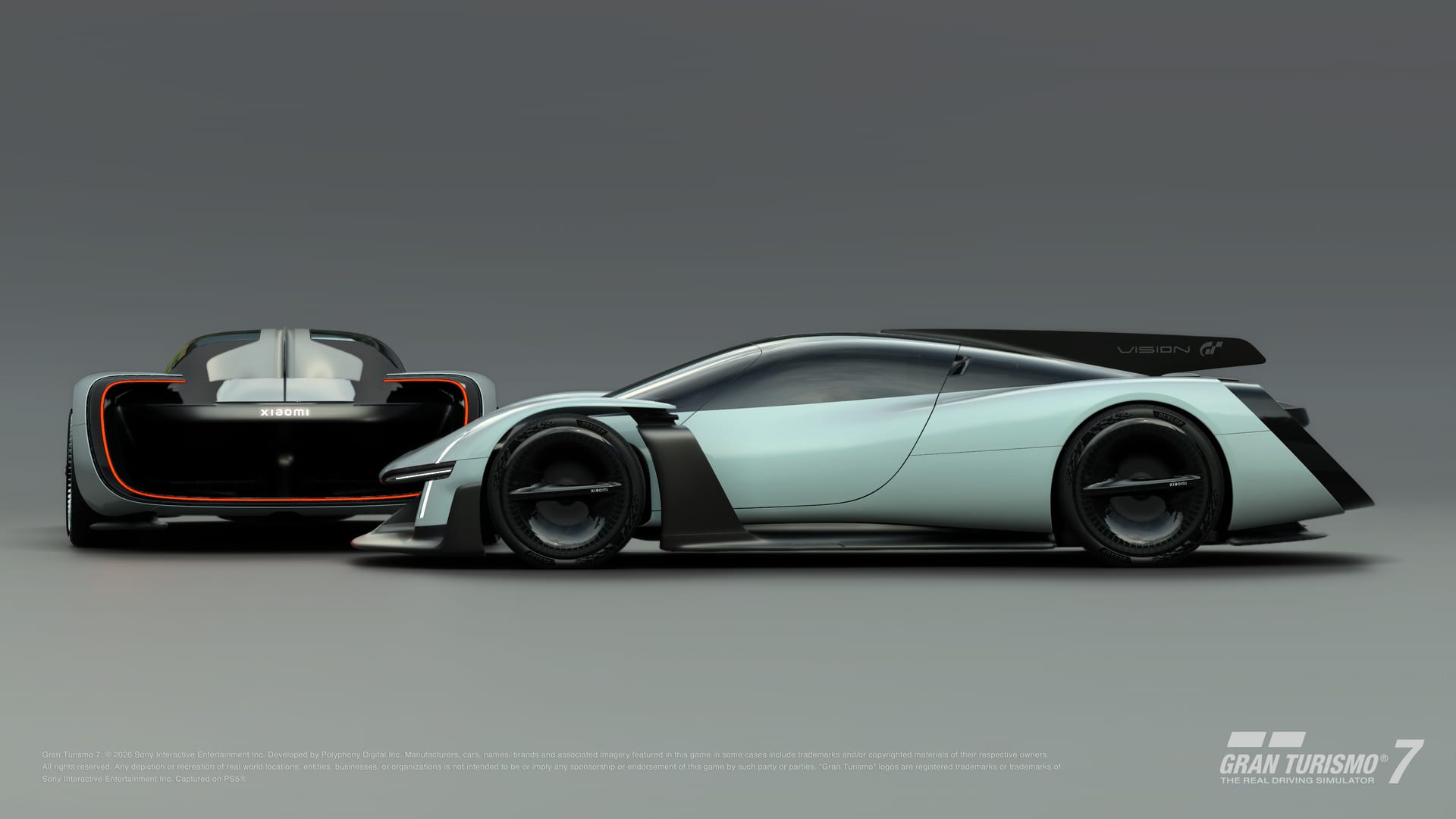Two views of the Xiaomi Vision Gran Turismo on a gray background, one from the rear with a glowing red stripe and one in profile, a light blue hypercar with a black wing.